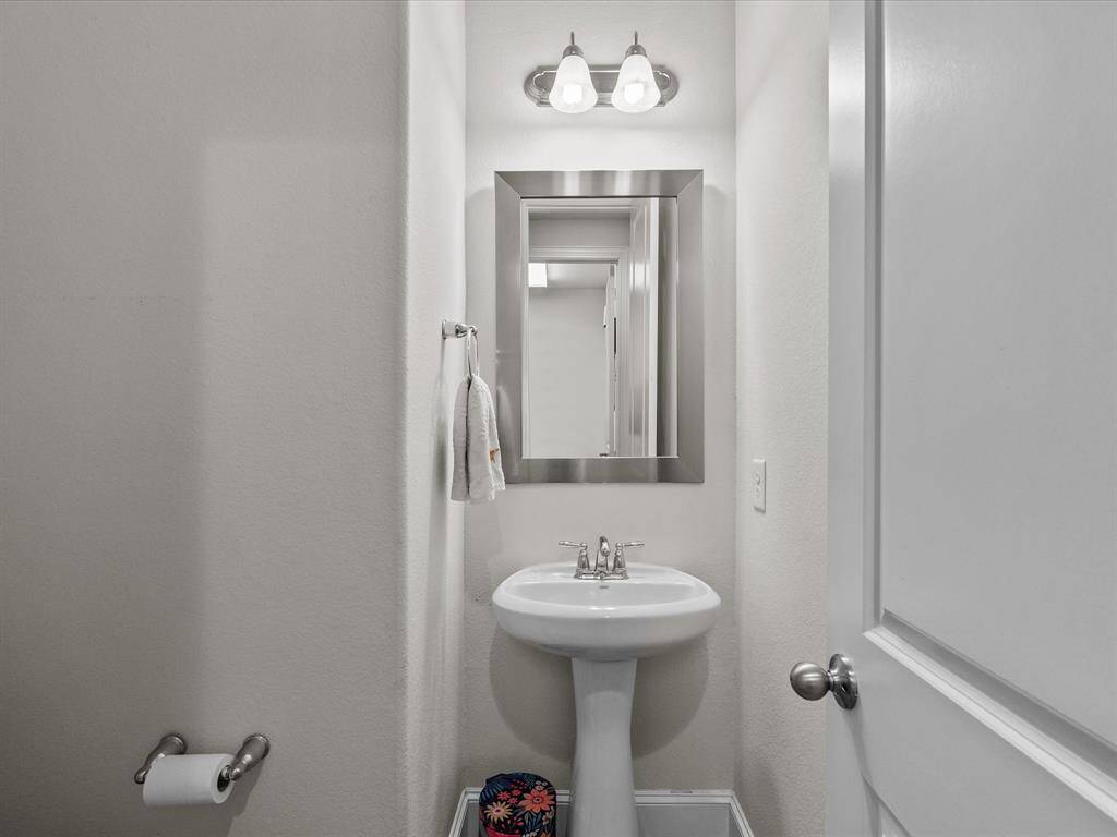 The Powder room is clean and elegant, just off the main hall and adjacent to the media room.