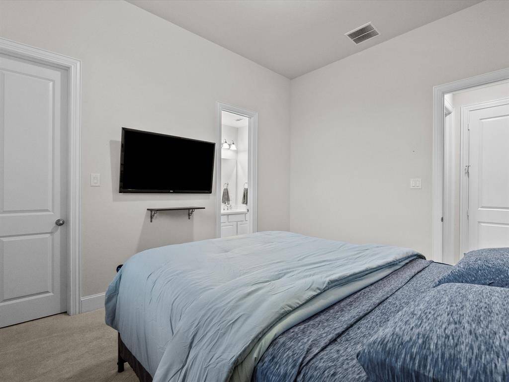 A different view of the cozy room displays its natural light and space to mount a TV on the wall.
