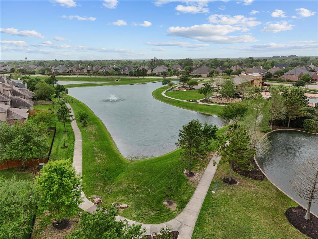 A further amenity lake has a water feature and a shaded walking path.