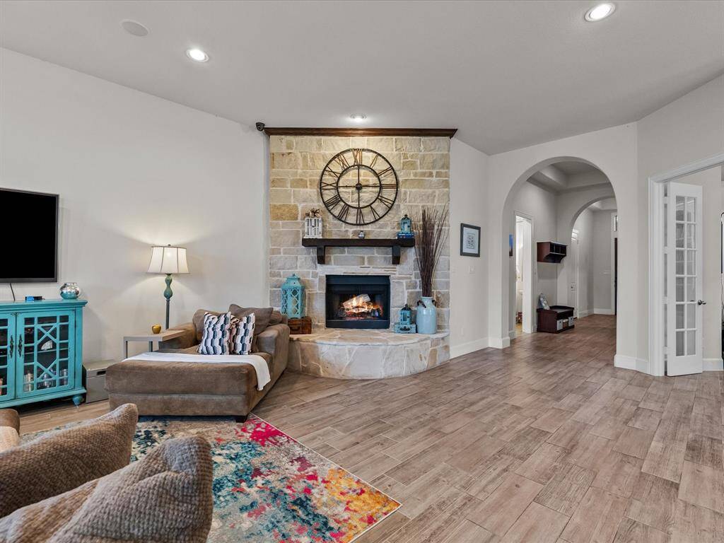 Large stone fire place is captivating and add coziness to this very large family room.