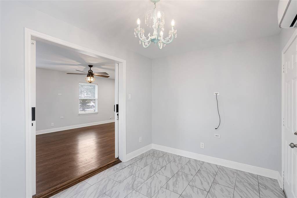 Sliding barn doors open to reveal this additional space. It can be used as an office, media room, home gym, or more!