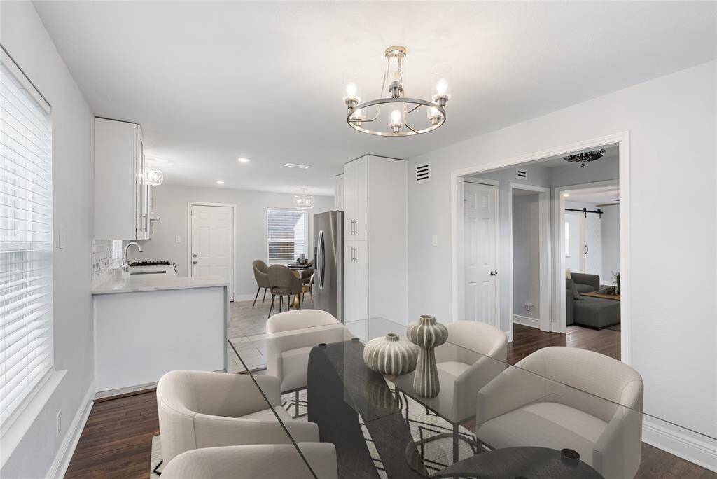 On the other side of the living room is the dining and kitchen areas! This spacious area is the perfect place to gather with loved ones for a delicious dinner! *virtually staged photo*