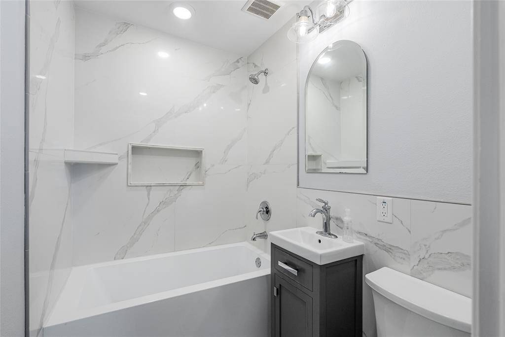 The spa-like primary suite is filled with elegant features, like stunning tile and modern tub!