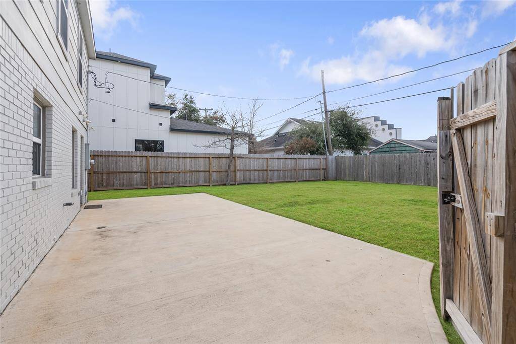 The rare backyard provides space for multiple outdoor activities! Imagine enjoying a lazy afternoon with loved ones on this patio!