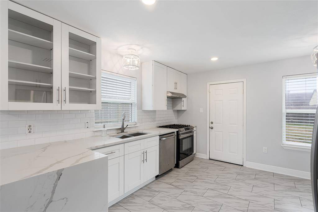 Elegant finishes are found all throughout the home, especially the kitchen! Waterfall quartz counters, shaker-style cabinetry and stunning light fixtures
