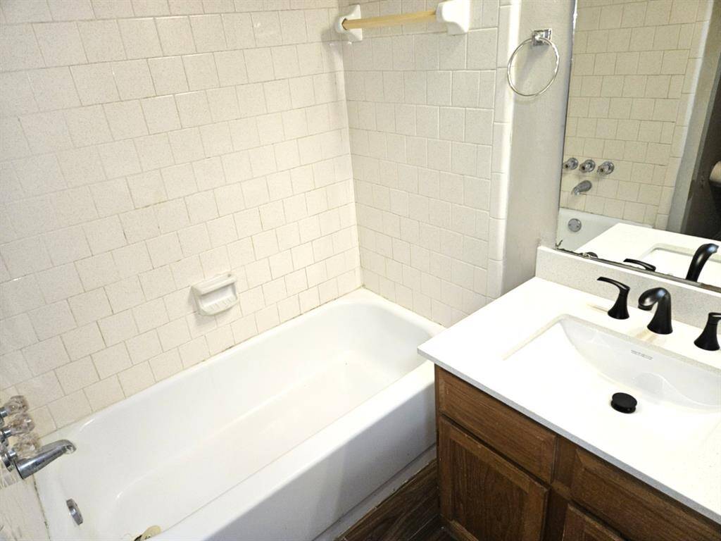 Luxurious guest full bath with stylish fixtures and a pristine tub, perfect for comfort and relaxation.