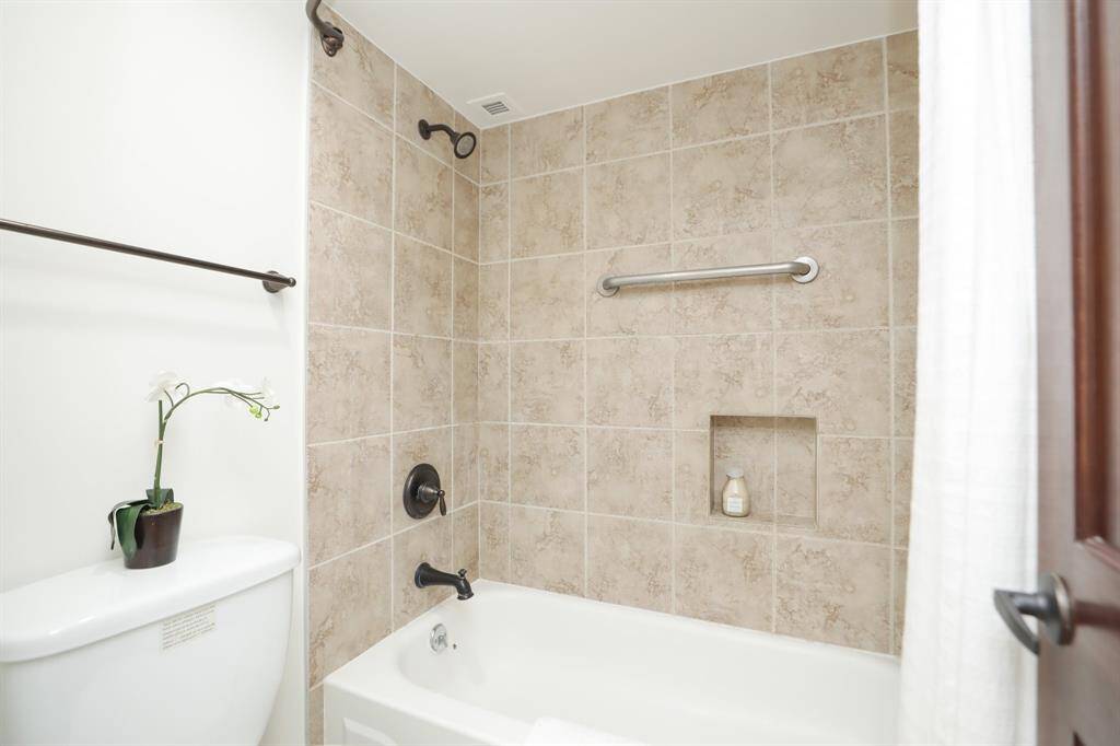 Combination tub and shower with tile insets.