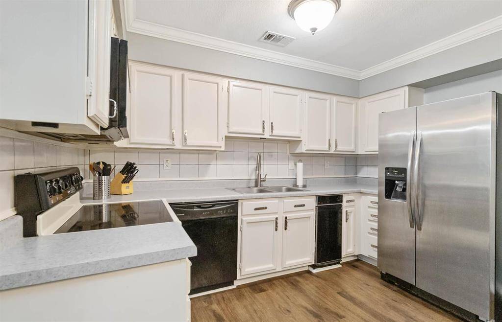 Family room features a gorgeous flooring and a glass sliding door access to the back patio. *This room has been virtually staged.