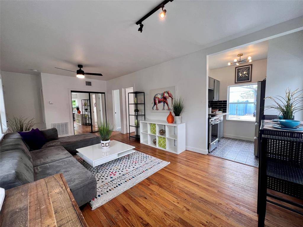 A secondary view of a 1 bedroom unit. Living space opens to a kitchen with ample windows proving natural light throughout.