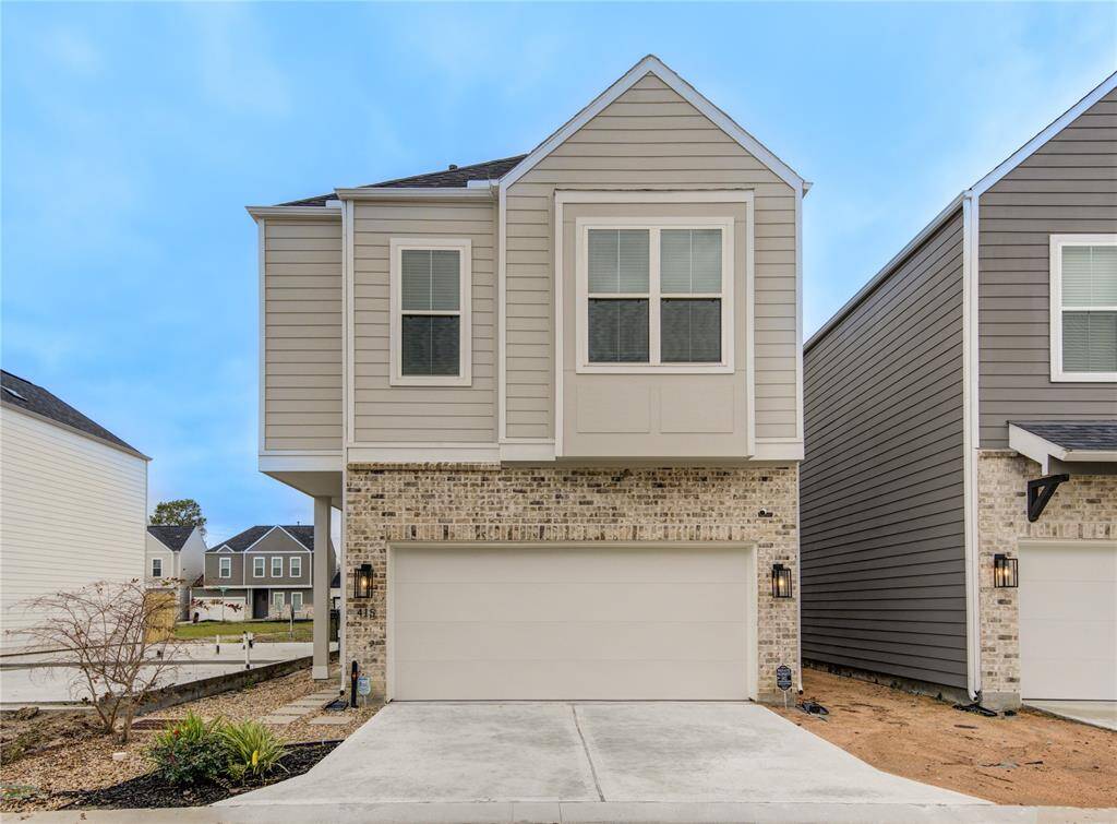 This modern two-story home features a brick and siding exterior with a double garage. It's part of a cozy neighborhood with similar style homes and a well-maintained front yard. Ideal for families seeking a contemporary living space.