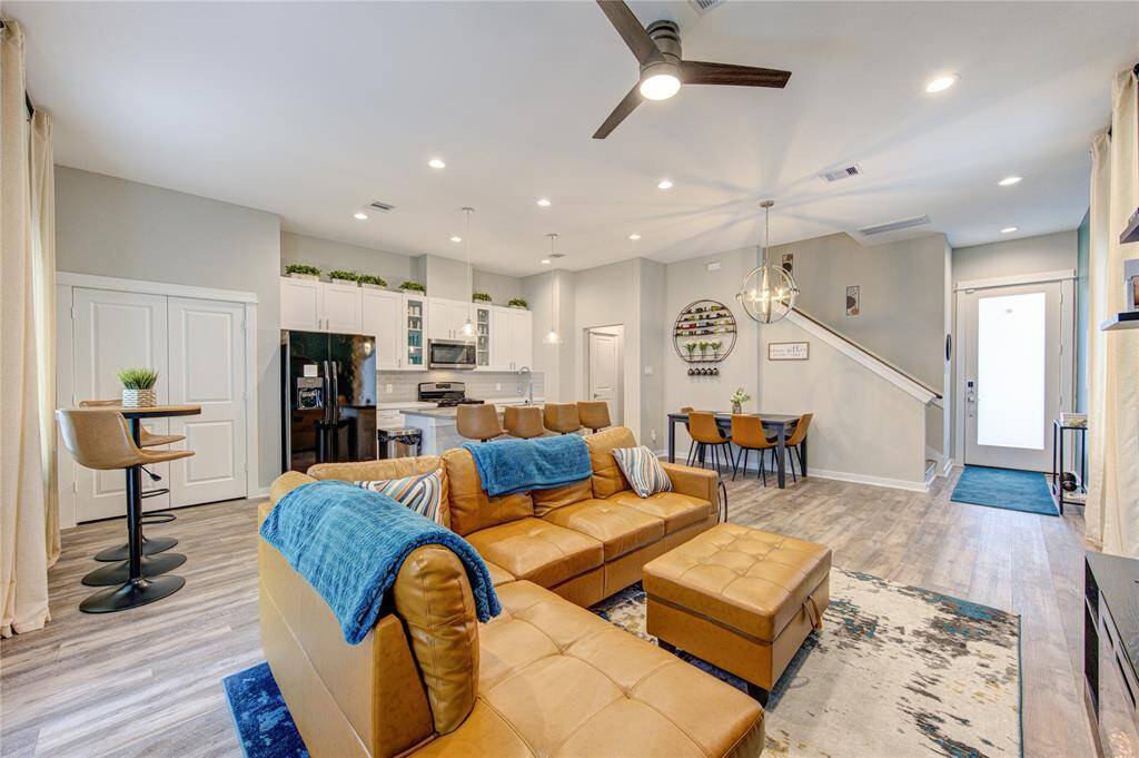 Open-concept living area, this space is bright with recessed lighting and a ceiling fan, offering a welcoming and functional environment.