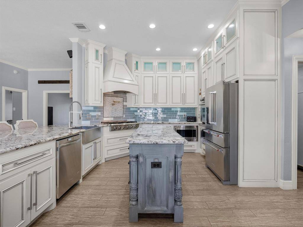 Recessed lighting illuminates the area and the white cabinetry is both classic and contemporary.