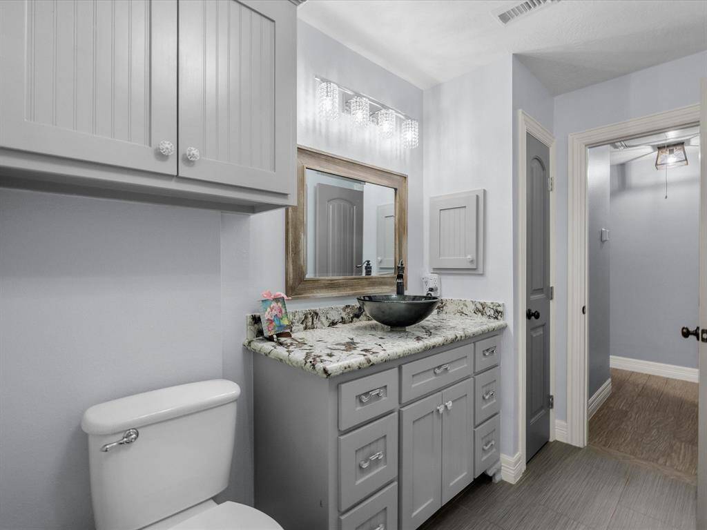 The en-suite bathroom has been upgraded with new cabinets, counters, and a basin.