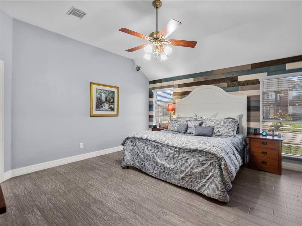 This room benefits from two windows and tasteful accent wall