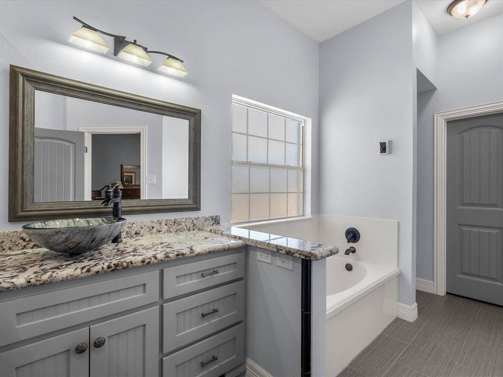 Custom bathroom with granite counters.