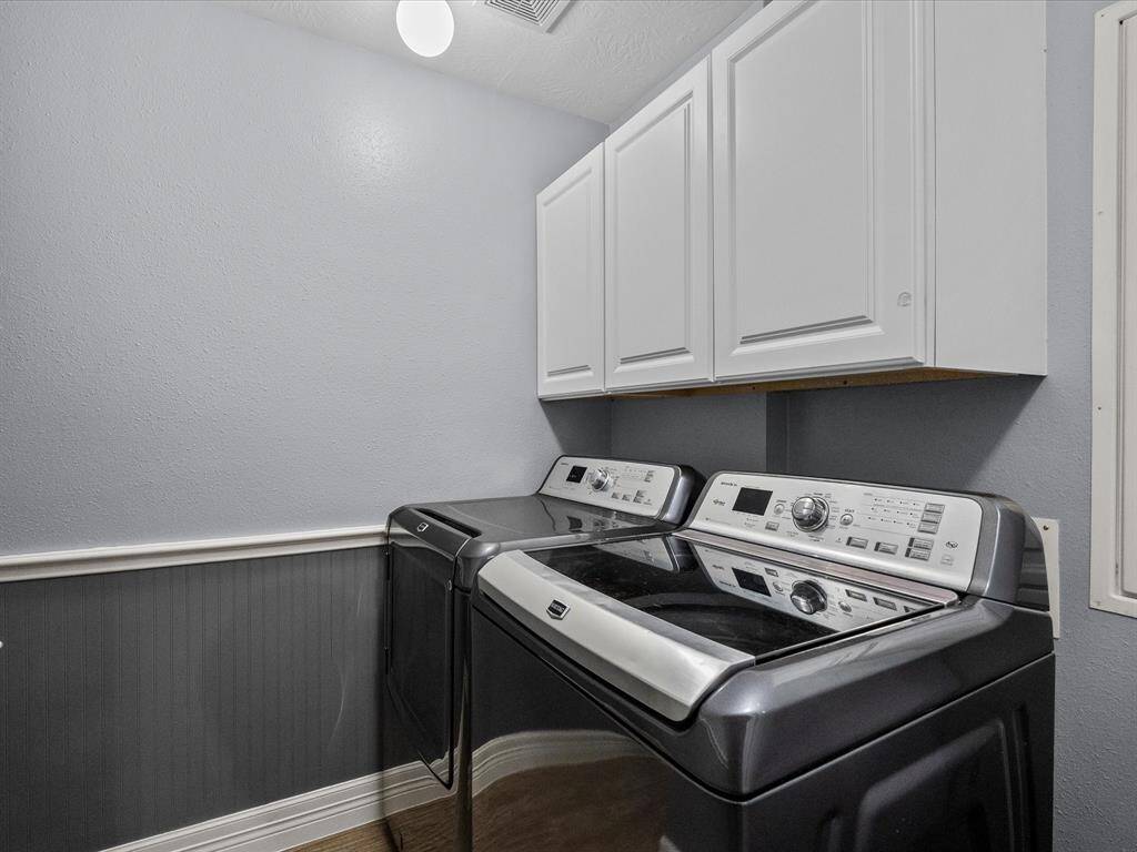 The laundry room is clean, modern, and utilitarian.