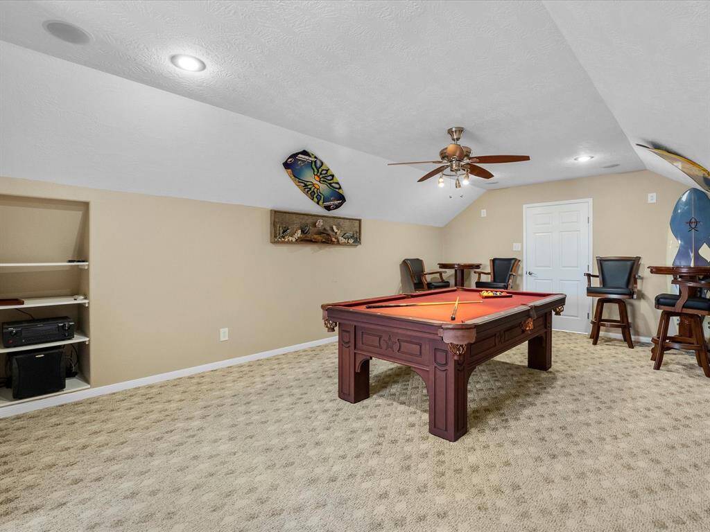 The upstairs garage space is large and has an adjoining bathroom and storage room