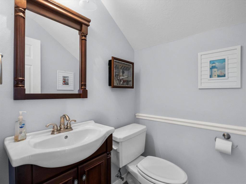 Two-piece bathroom above the garage space.