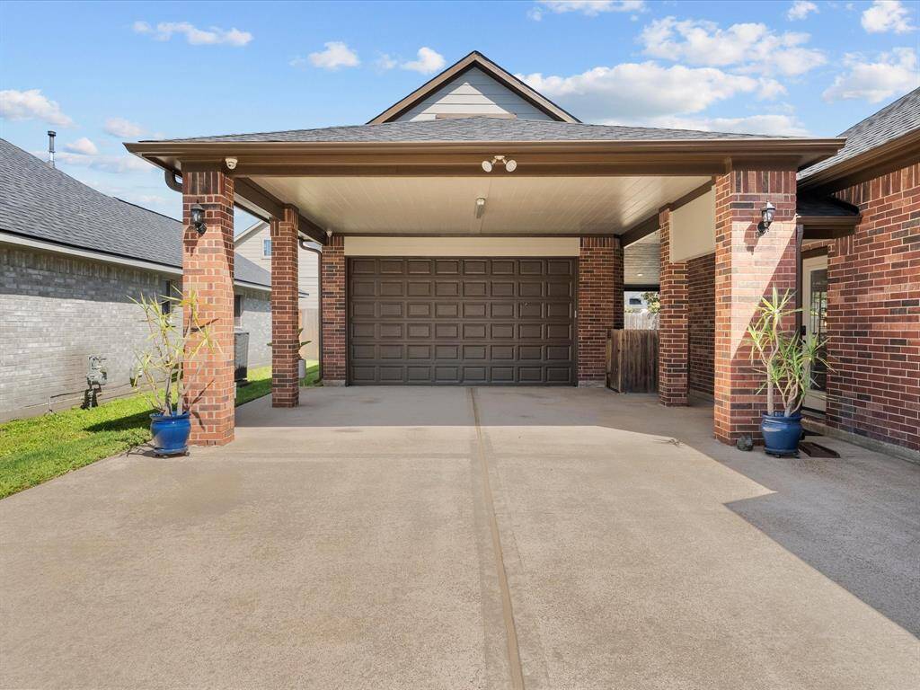 There is a covered carport for two cars in front of the garage, and access to the house.