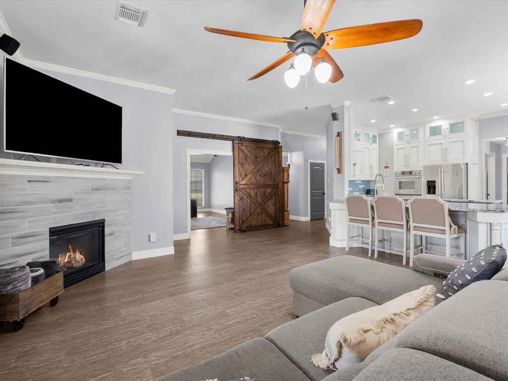 The house has porcelain tile throughout and is wired for home surround sound.
