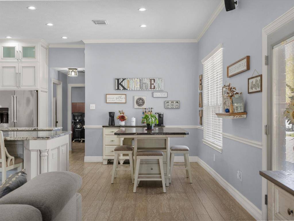 The breakfast nook is well lit and located. The home has crown molding throughout.