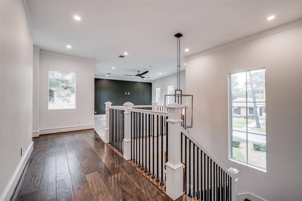 Second floor game room has plenty of space to gather with family and friends for watching a ball game or movie nights.