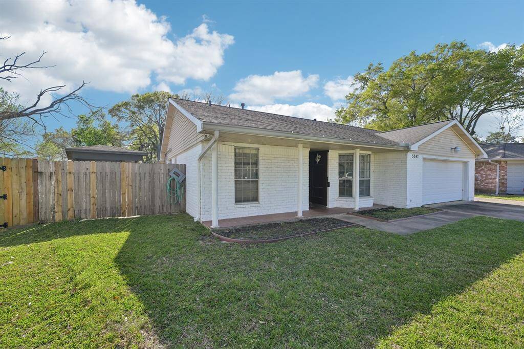 Side access to the left of the home with a covered parking/relaxing area