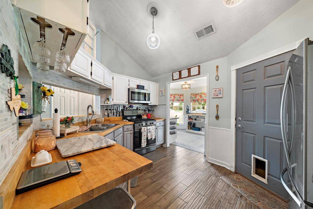 With its butcher block countertops and abundance of storage, this kitchen is a chef's paradise. Both the oven and stove are gas. which is sure to reduce your electricity expenses.