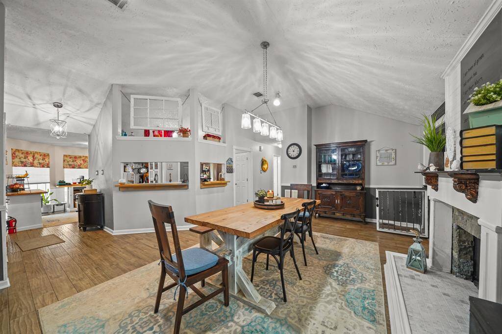 This spacious dining room with a cozy fireplace is the perfect size for family get-togethers.