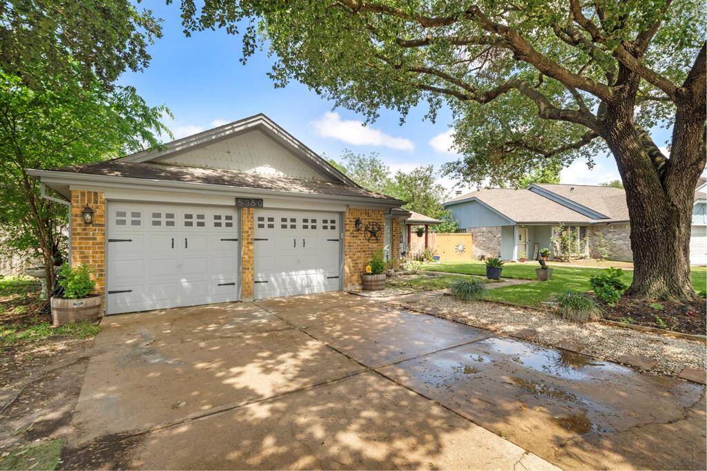 This ranch-style house has a two-car attached garage and a double-wide driveway.