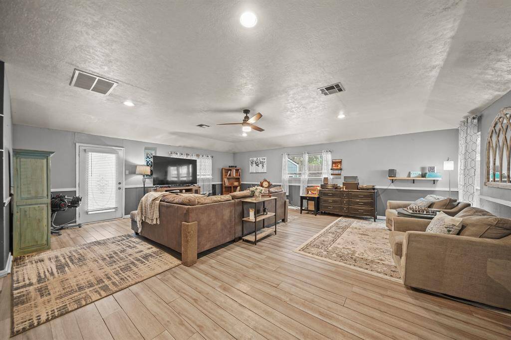 Light and bright living room.  Lots of room and ample storage with sliding doors out to patio and deck