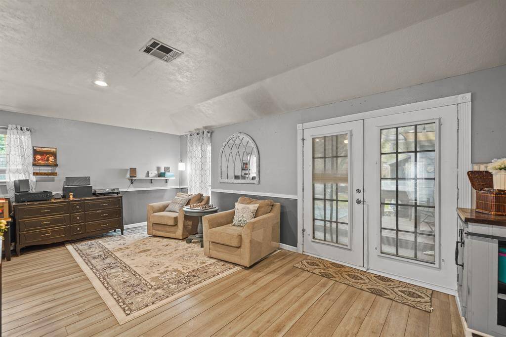 Another view of living room with doors out to patio and deck