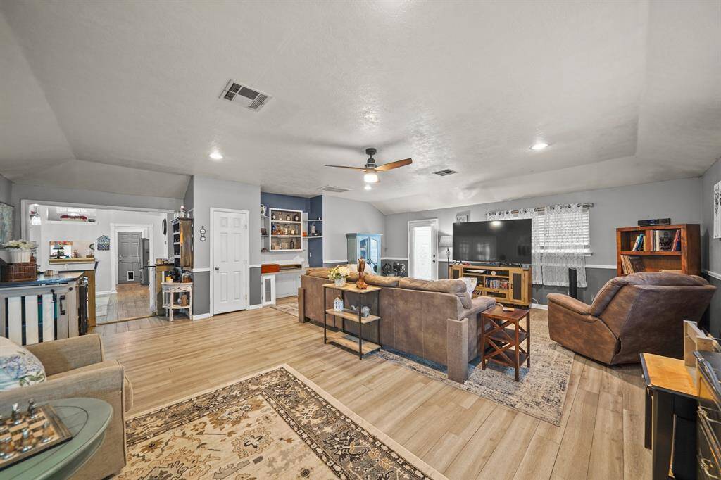 View of living room with easy access to kitchen and dining room