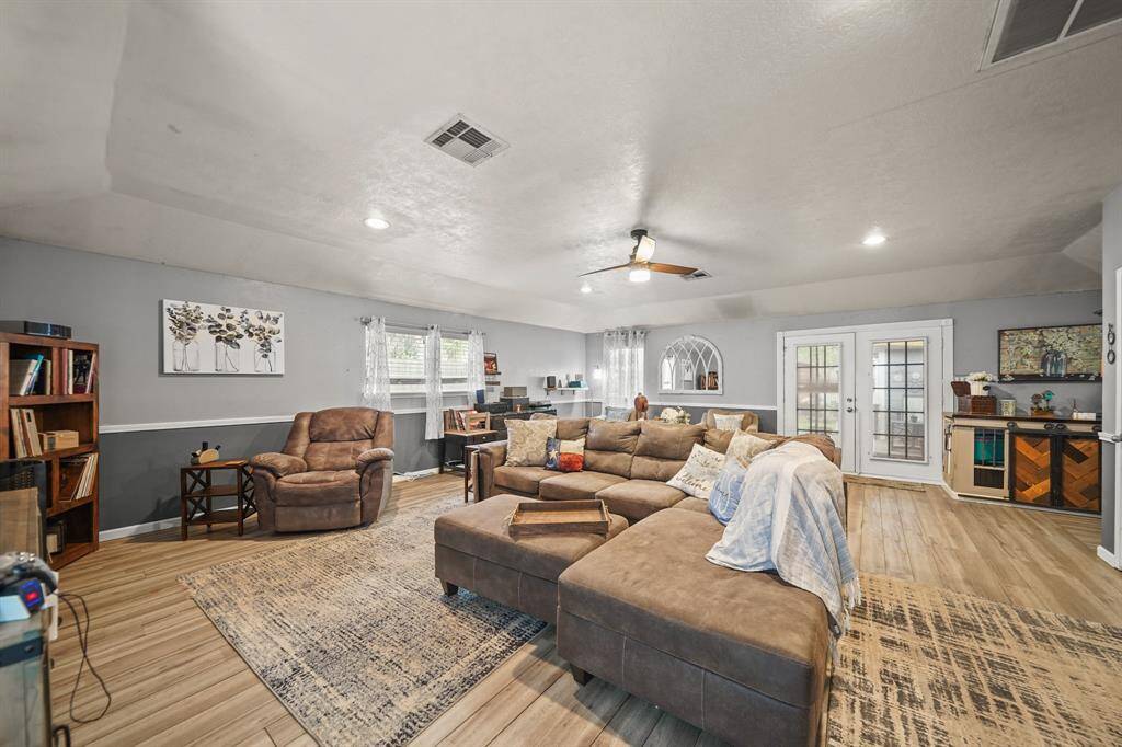 Another view of living room with ceiling fan and recessed lighting.
