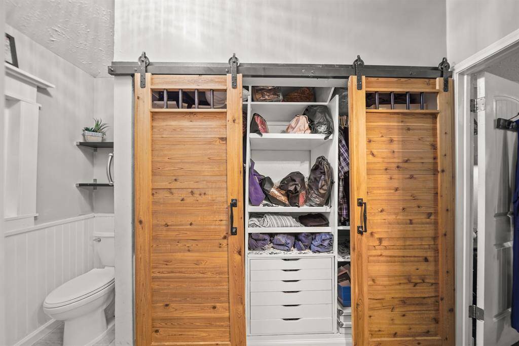 Custom closet space and storage with barn doors.