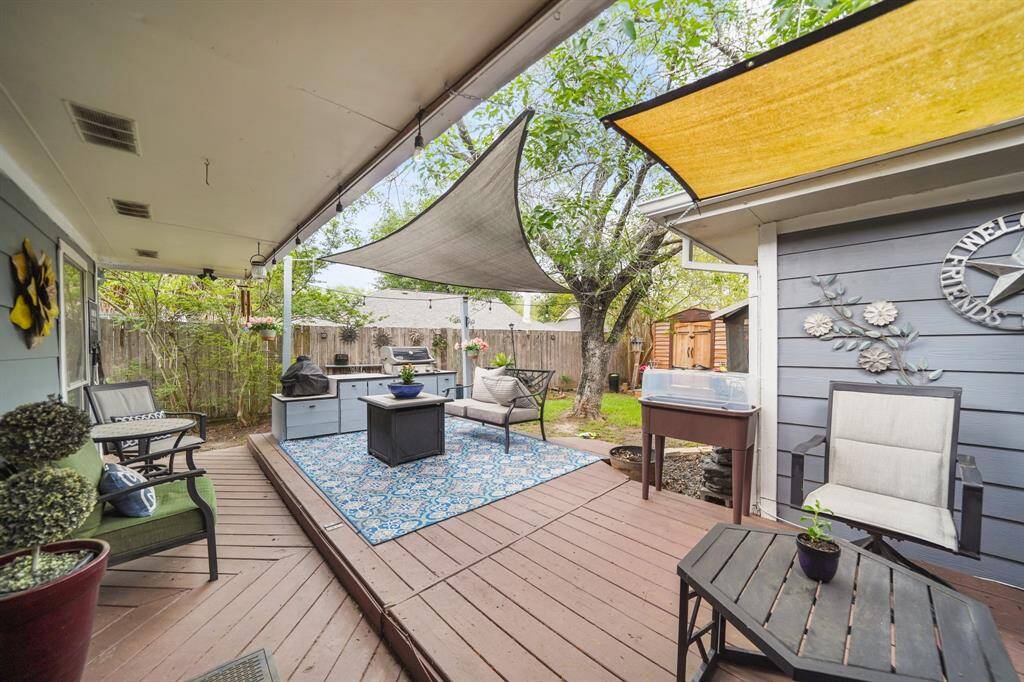 Spacious covered back patio with deck. The patio furniture will remain with the property if you like.