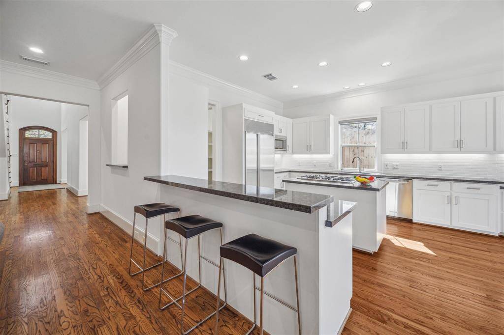 Chef's kitchen with island and bar seating