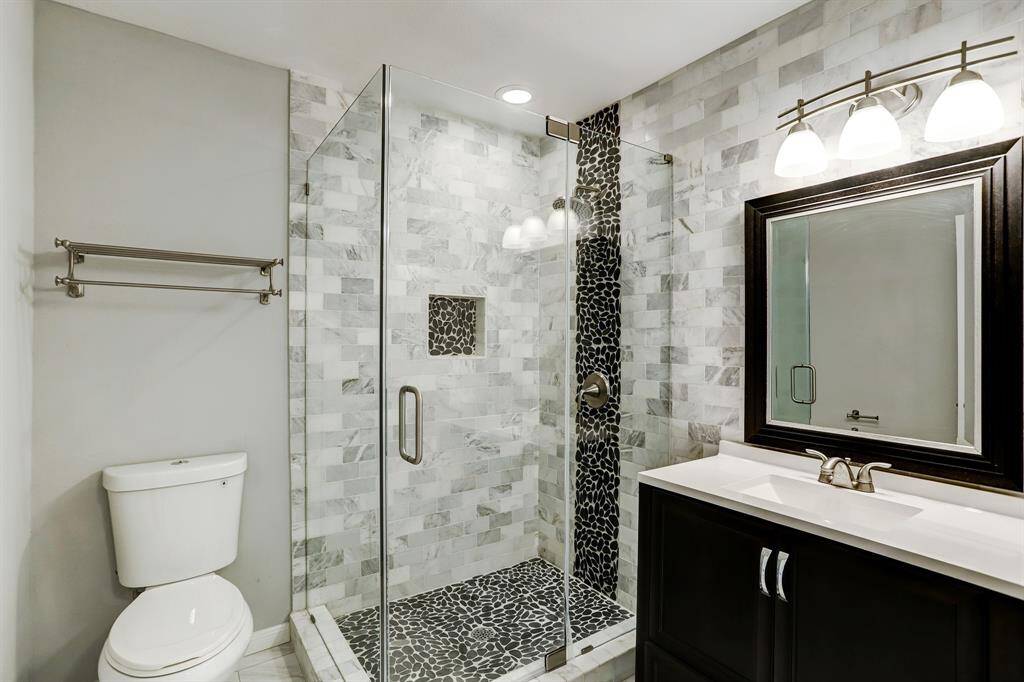 Completely renovated secondary bathroom with easy access to the family room and laundry area.