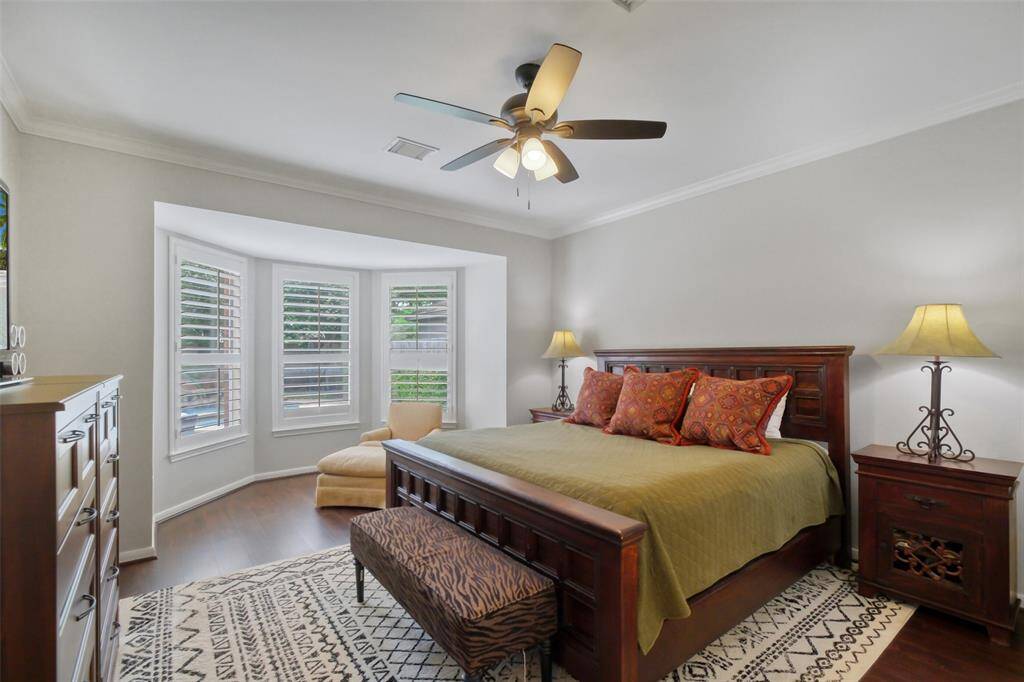 THE SPACIOUS PRIMARY BEDROOM FEATURES  A BEAUTIFUL BAY WINDOW THAT FILLS THE ROOM WITH NATURAL LIGHT AND PROVIDES A COZY SITTING AREA.