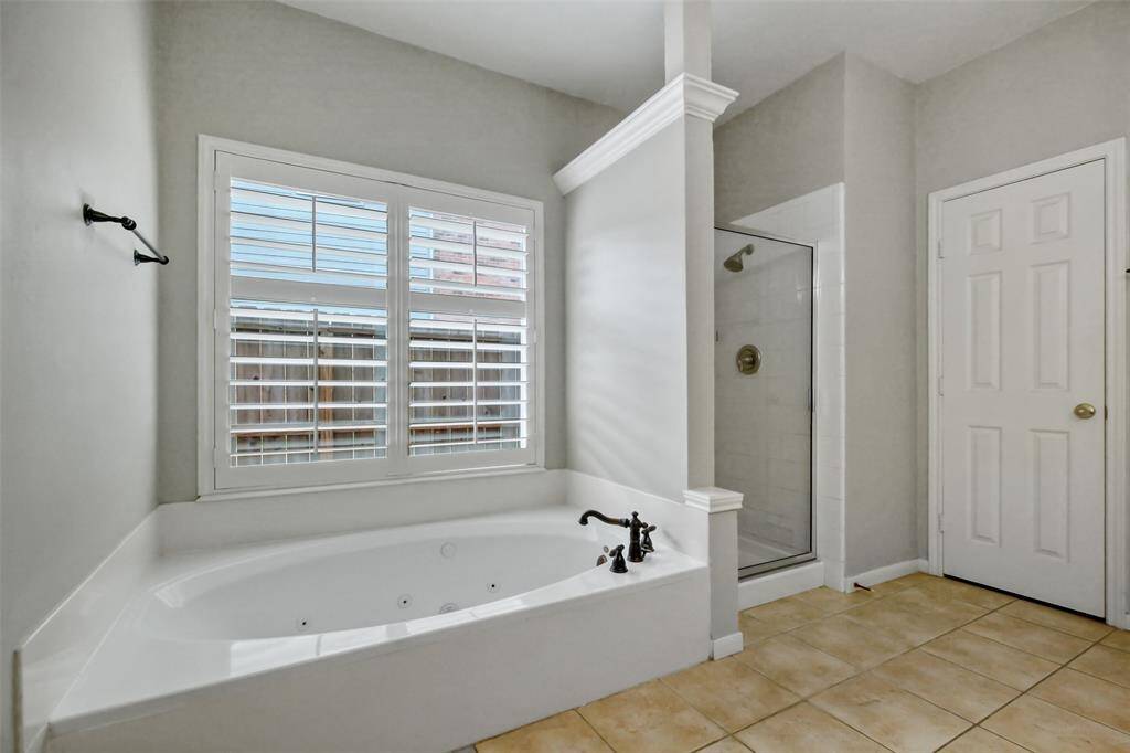RELAX IN THE LUXURIOUS JETTED BATHTUB OR REFRESH IN THE SEPARATE ENCLOSED SHOWER.