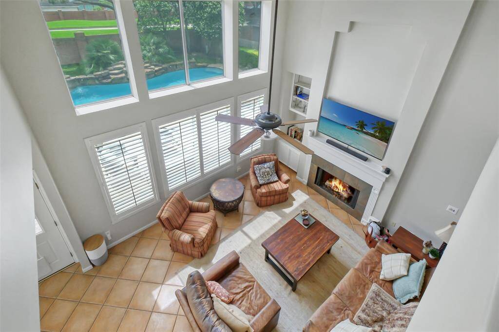 OVERLOOKING THE GREATROOM, THIS STUNNING VIEW SHOWCASES THE SPACIOUS ROOM AND BEAUTIFUL BACKYARD.