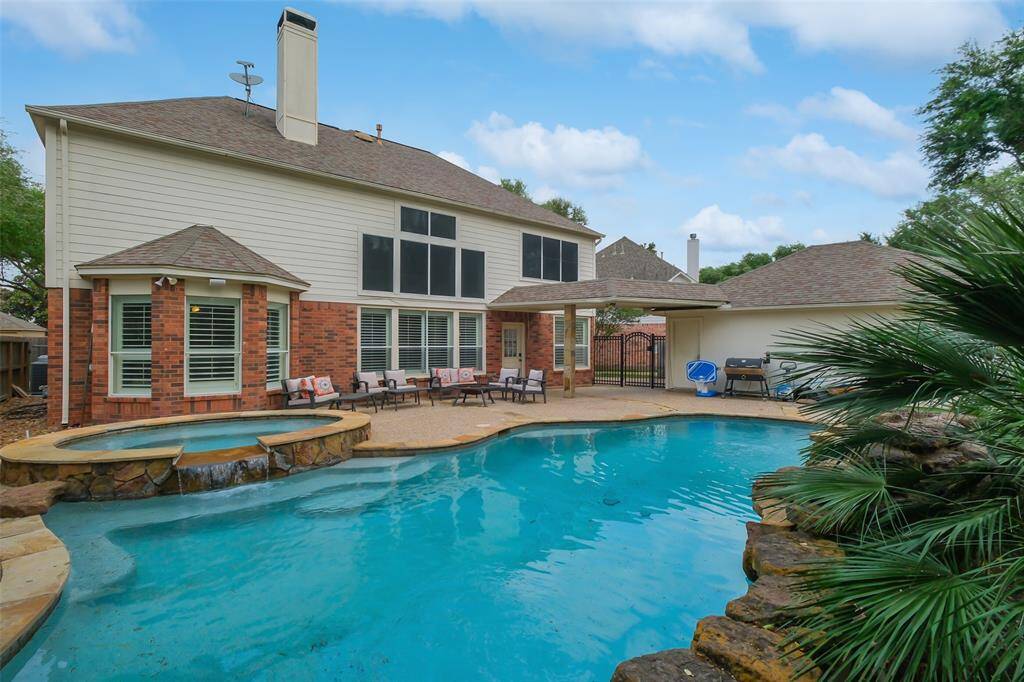 THIS BACKYARD IS A DREAM COME TRUE WITH A CRYSTAL-CLEAR POOL, RELAXING SPA, AND PLENTY OF LOUNGE SPACE FOR ENTERTAINING.
