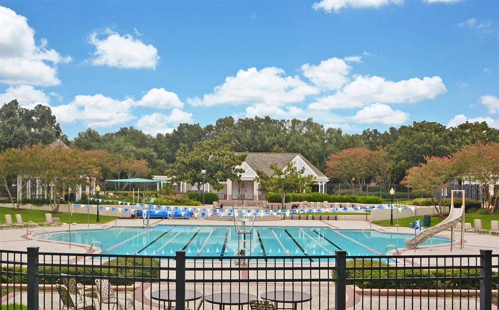 This resort-style pool offers lap lanes, a kiddie pool, and a spacious deck area perfect for relaxing or socializing.