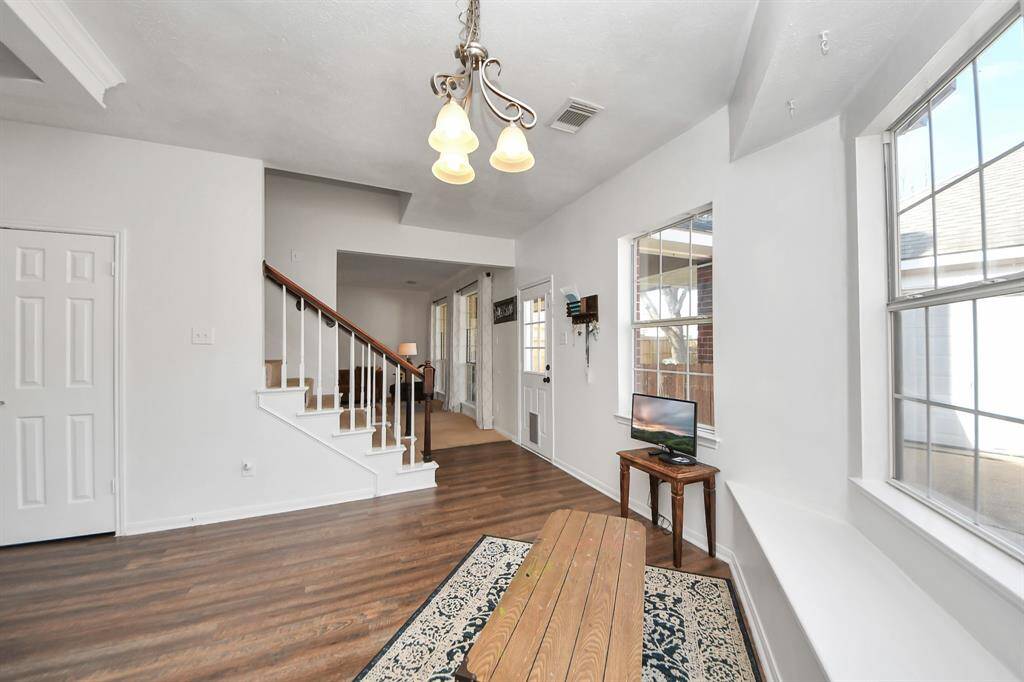 View from breakfast to living room with rear-facing staircase. Easy access to backyard covered patio for the perfect grilling station location.