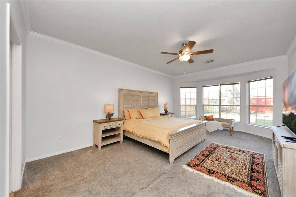 Spacious primary suite with bay window overlooks backyard and has an exit door for easy access to the back patio. This is a great spot for winding down at the end of the day.