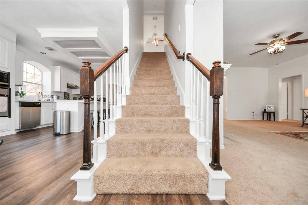 The stairs lead up to a lofty game room with vaulted ceilings.