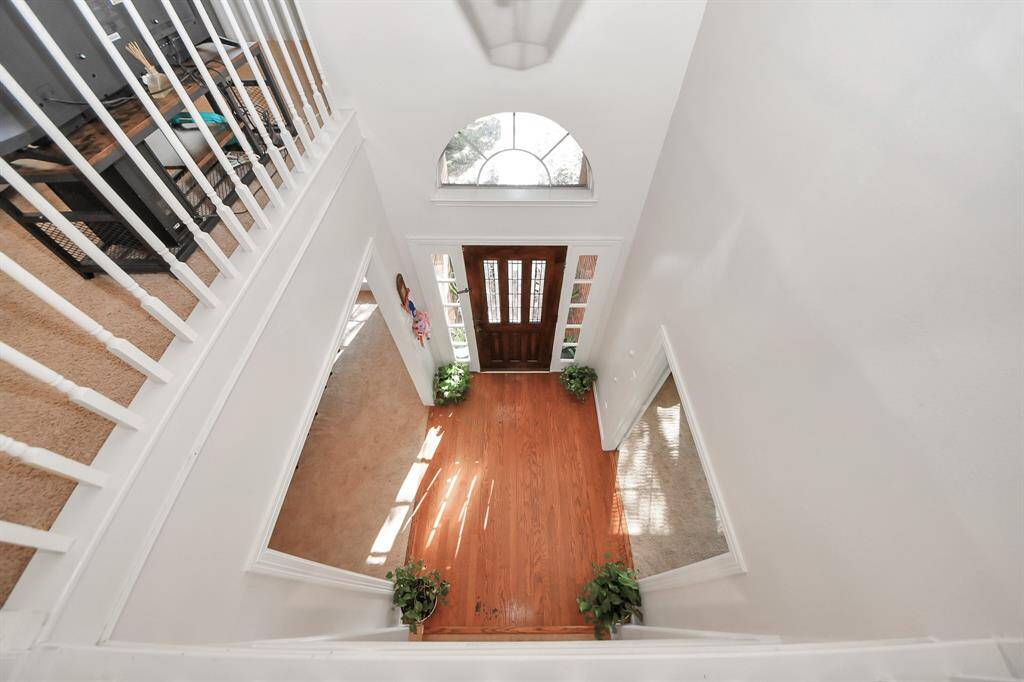 Looking down onto the foyer from the second story game room.