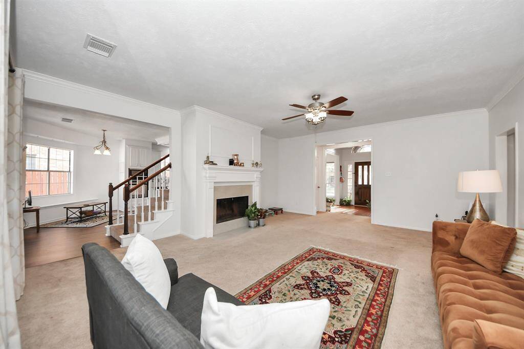 Gas fueled fireplace was recently updated with new tile (2025) and makes for a cozy space. This warm and welcoming room overlooks the backyard with large covered patio.