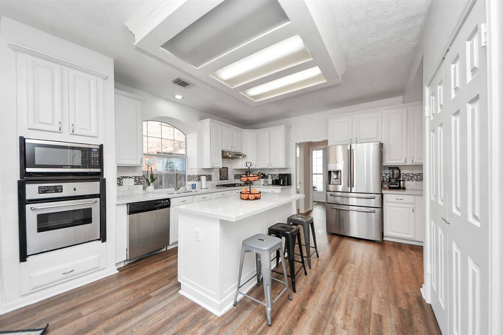 This gourmet island kitchen was updated a few years ago and includes beautiful 42" painted cabinetry with a tile & mosaic back splash and decorative space above, along with plenty of counter top, drawer & storage space.