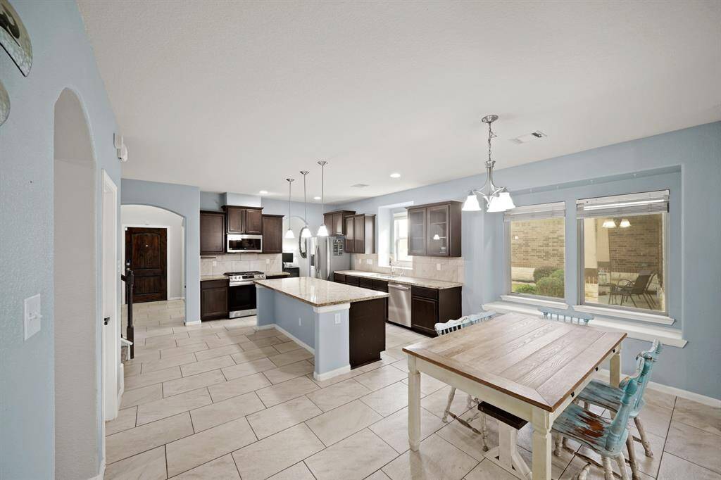 The breakfast nook includes a beautiful pendant lighting and large windows.